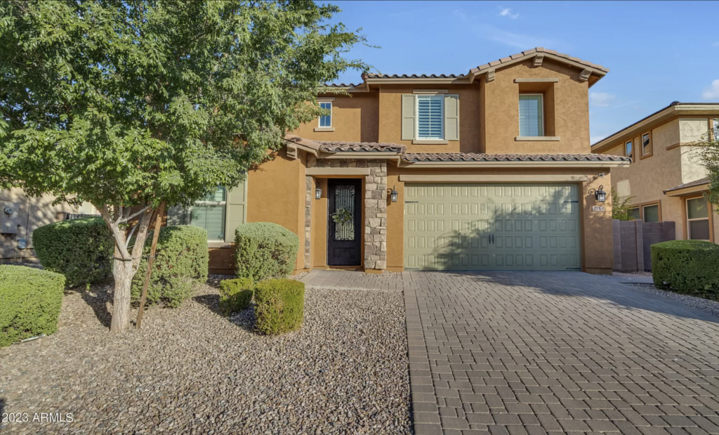Phoenix home with green garage and orange stucco
